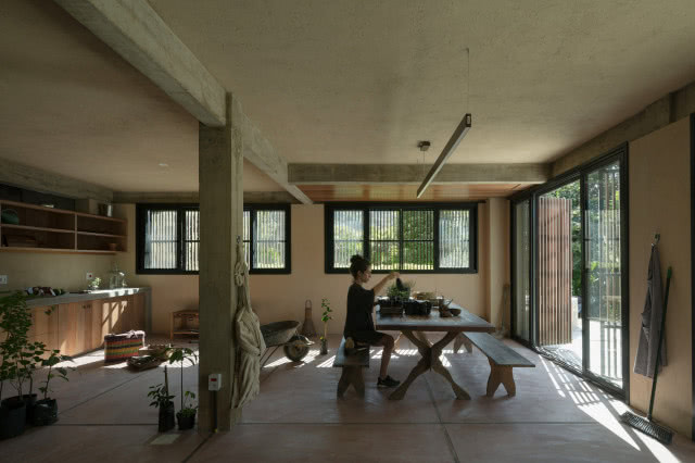 kobieta przy stole przesadza rośliny