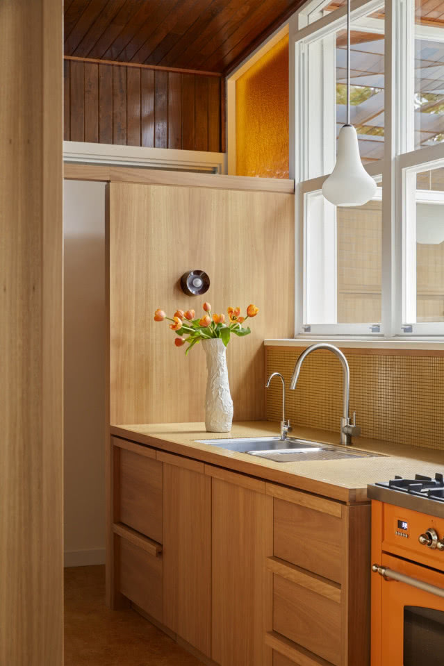 kuchnia w drewnie z pomarańczową kuchenką
