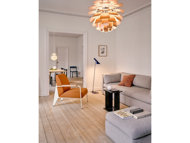 pokój z fotelem, kanapą i lampą wiszącą