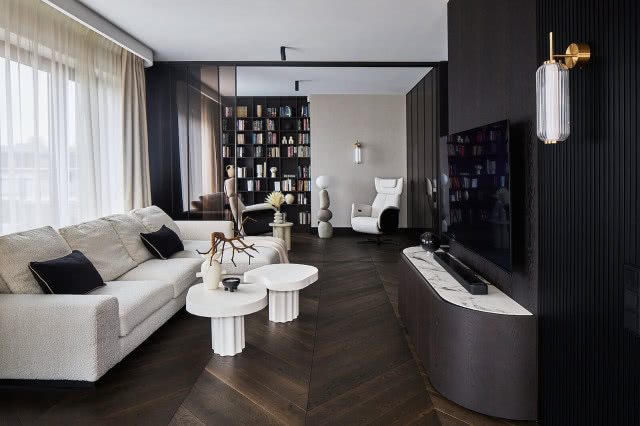 przestronny salon z biblioteką i podłogą z dębowej jodełki 