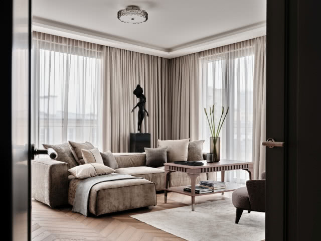 beżowy salon w stonowanych barwach z ciemnym drewnem