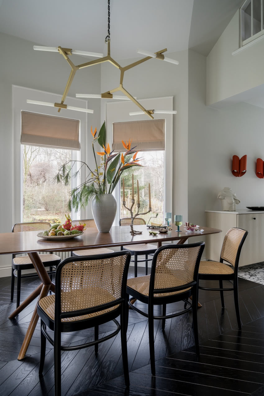 Na stole wazon BoConcept. Krzesła marki TON. Na...