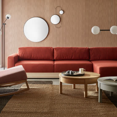 kanapa, fotel, stoliki kawowe, okrągłe lustra na ścianie. lamele na ścianie, lampa sufitowa, lampa podłogowa, dywany, firany