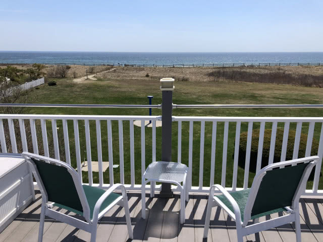 dwa leżaki na tle morza