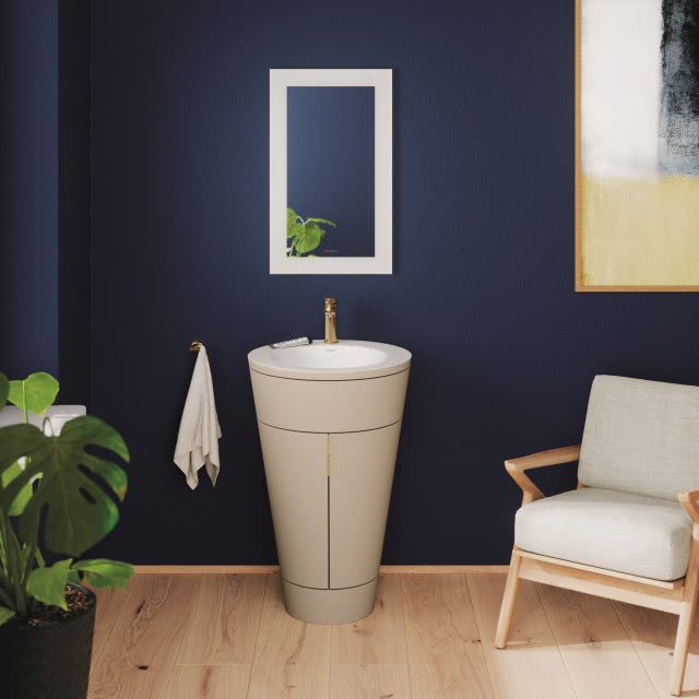 biała umywalka w kształcie stożka na tle granatowej ściany