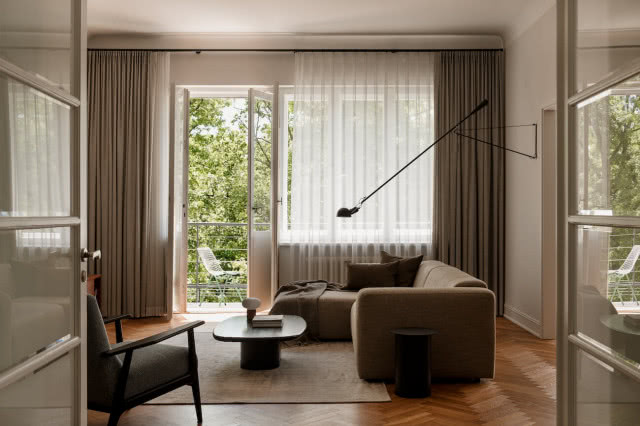 Salon z kanapą i ciekawą nowoczesną lampą 