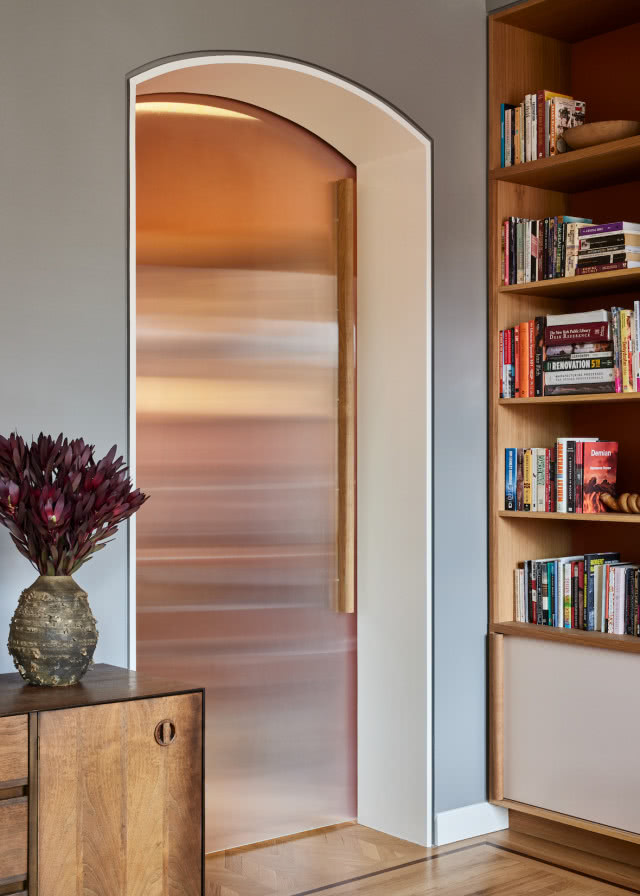 Na korytarz prowadzą szklane przesuwne drzwi.