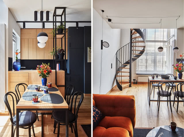 pomarańczowa kanapa w industrialnym salonie, czarna kuchnia z drewnianymi detalami i ażurowe schody