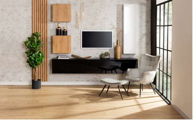 telewizor, biurko, duży zielony kwiat w doniczce, lamele ścienne, fotel, pufa, szafki na ścianie, wazon