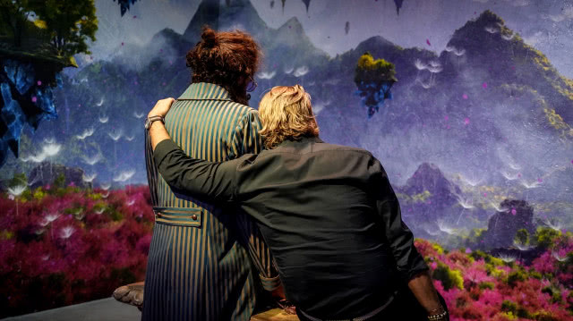 mężczyzna przytulający się do kukły ptaka Mateusza