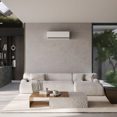 Nowoczesny salon z aneksem kuchennym i klimatyzatorem LG DUALCOOL AI Premium zamontowanym na ścianie.