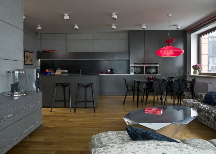 W utrzymanym w odcieniach szarości salonie uwagę...