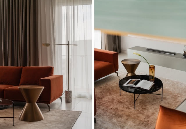 Designerski salon z rudą kanapą i czarnym stolikiem