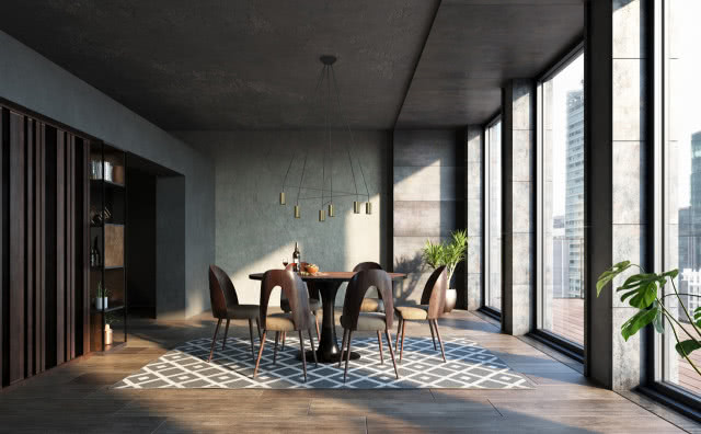 beton na ścianach i suficie, duży okrągły stół z krzesłami, lampy sufitowe, dywan, duże okna, drewniana podłoga, kwiaty