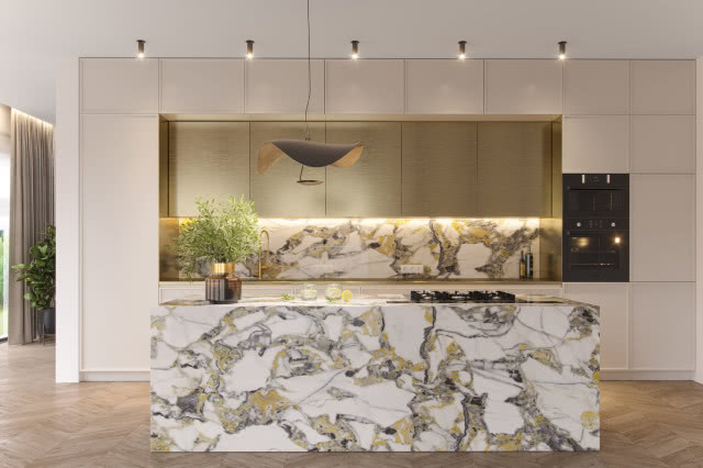 wyspa kuchenna, spieki kwarcowe złote, ekspres do kawy, wazon z zielonymi gałązkami, jodełka na podłodze