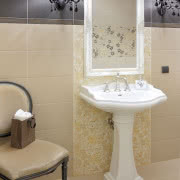 Beżowo-czarna łazienka na parterze pełni rolę...