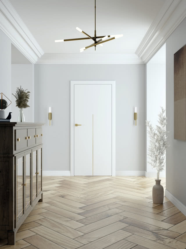 białe drzwi w przedpokoju, jodełka na podłodze, komoda