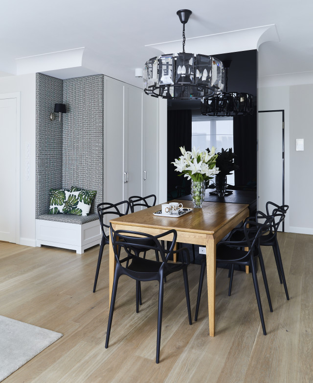 Kultowe krzesła marki Kartell przy dębowym stole.