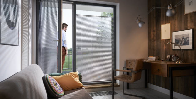 żaluzje anwis , krzesło , kanapa i pomarańczowa poduszka