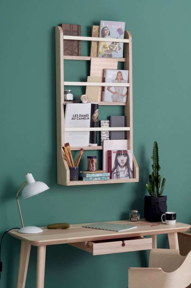 półka nad biurkiem wisi na zielonej ścianie
