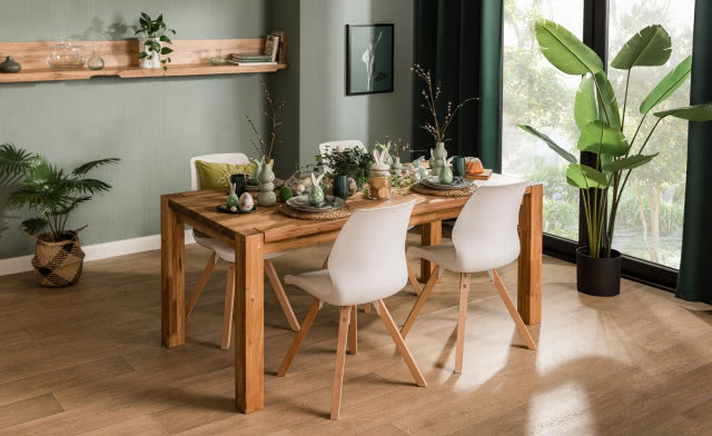 stół FREDI, krzesła, półka, oliwkowe ściany, drewniana podłoga, obraz, duże kwiaty w doniczce, zielone zasłony