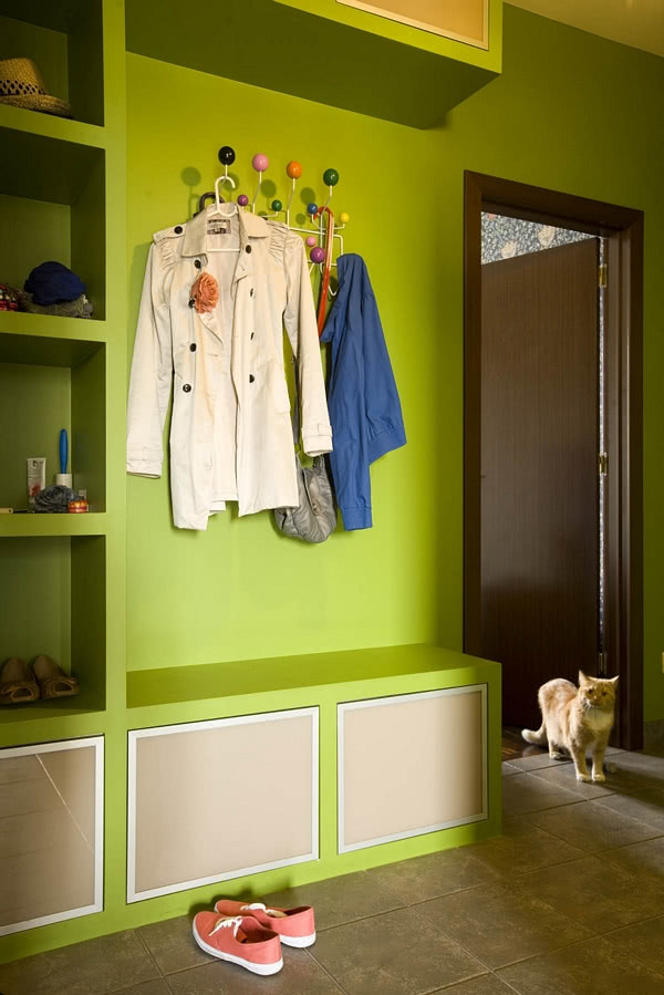 Ciepła zieleń ścian holu została powtórzona w...