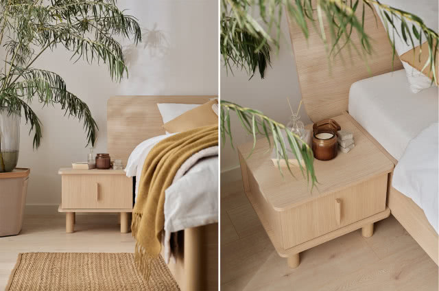 stolik nocny, gałęzie w wazonie, świeca zapachowa, łóżko, dywan