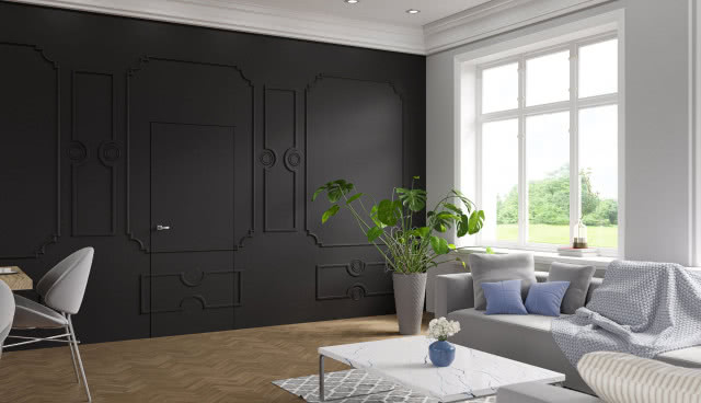 ukryte drzwi pod sztukaterią, kanapa, poduszki ozdobne, koc, stolik kawowy, krzesło, monstera, dywan