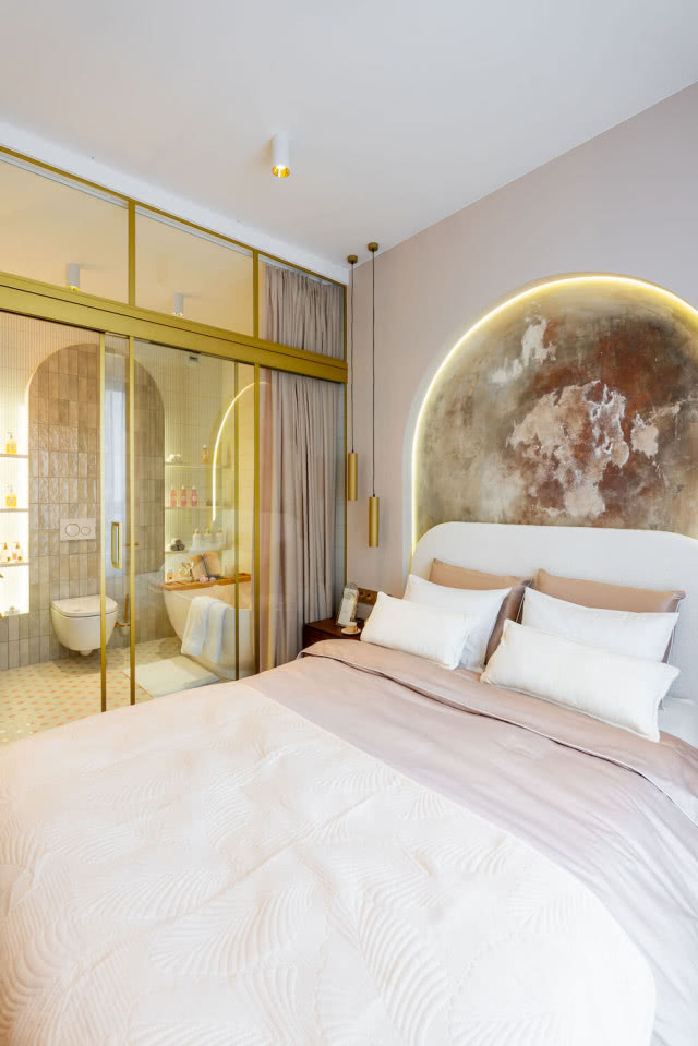 sypialnia z łazienką połączona szklaną ścianą