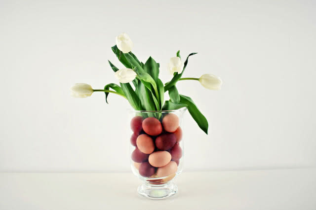 szklany wazon, kolorowe jajka, białe tulipany