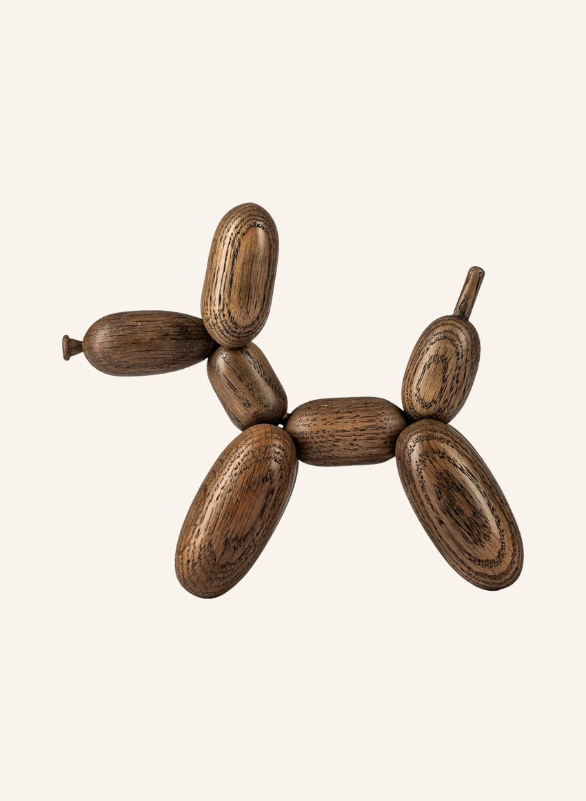 Drewniana figurka w kształcie pieska przypomina...